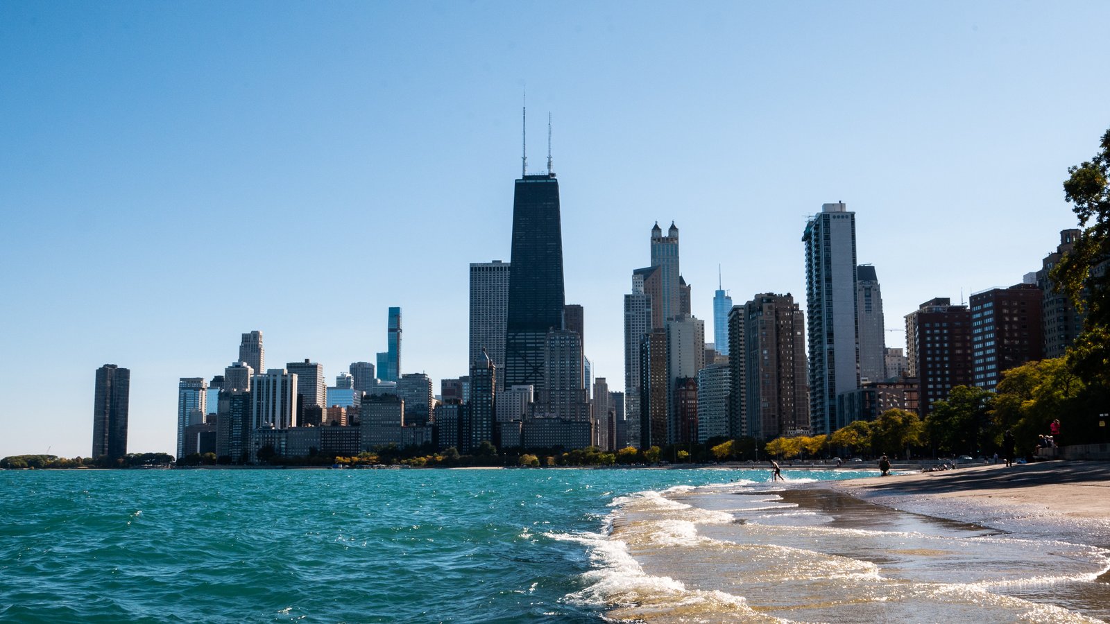 city skyline across body of water during daytime